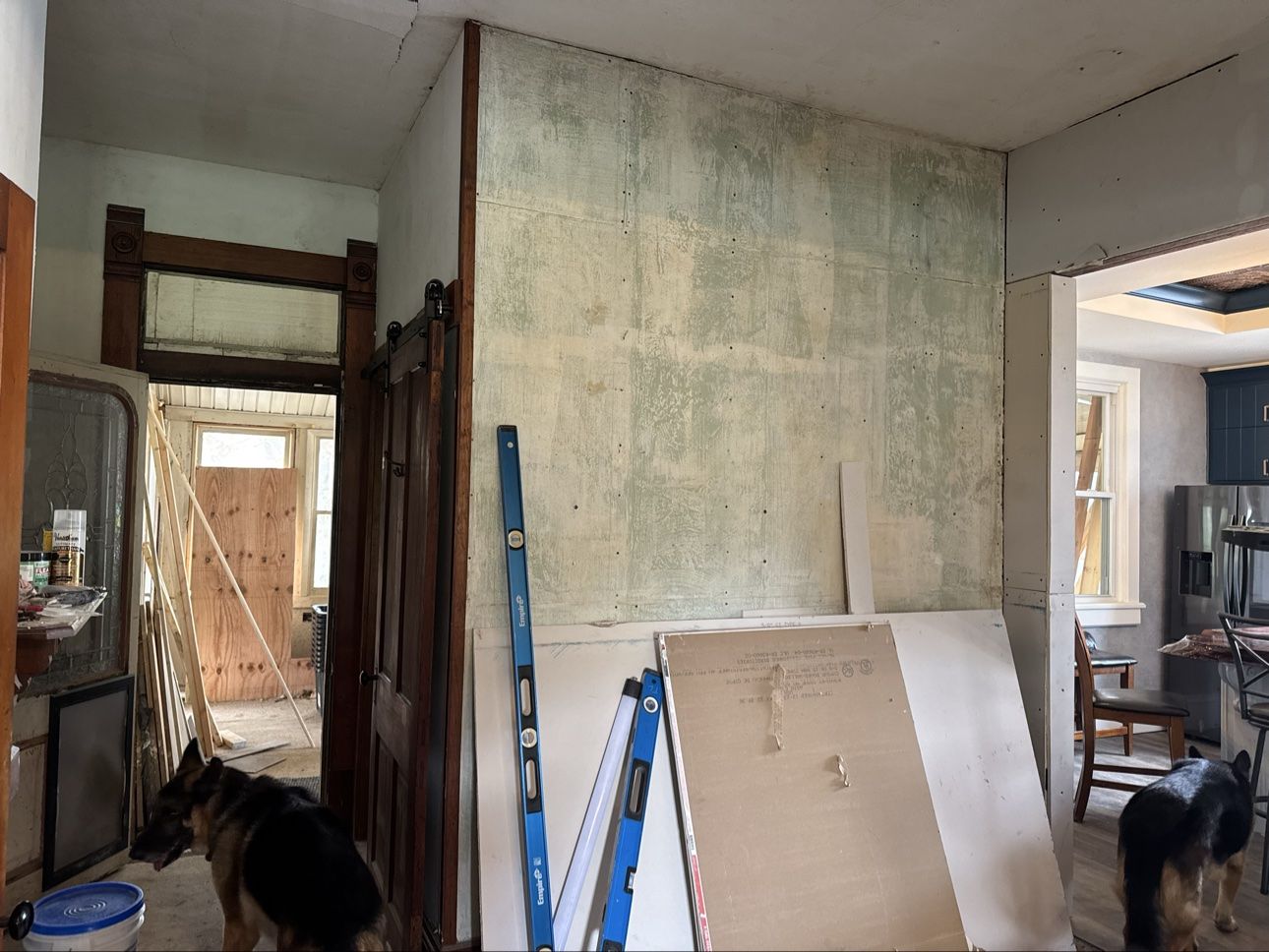 1800s hallway before restoration, walls stripped and ceiling failing