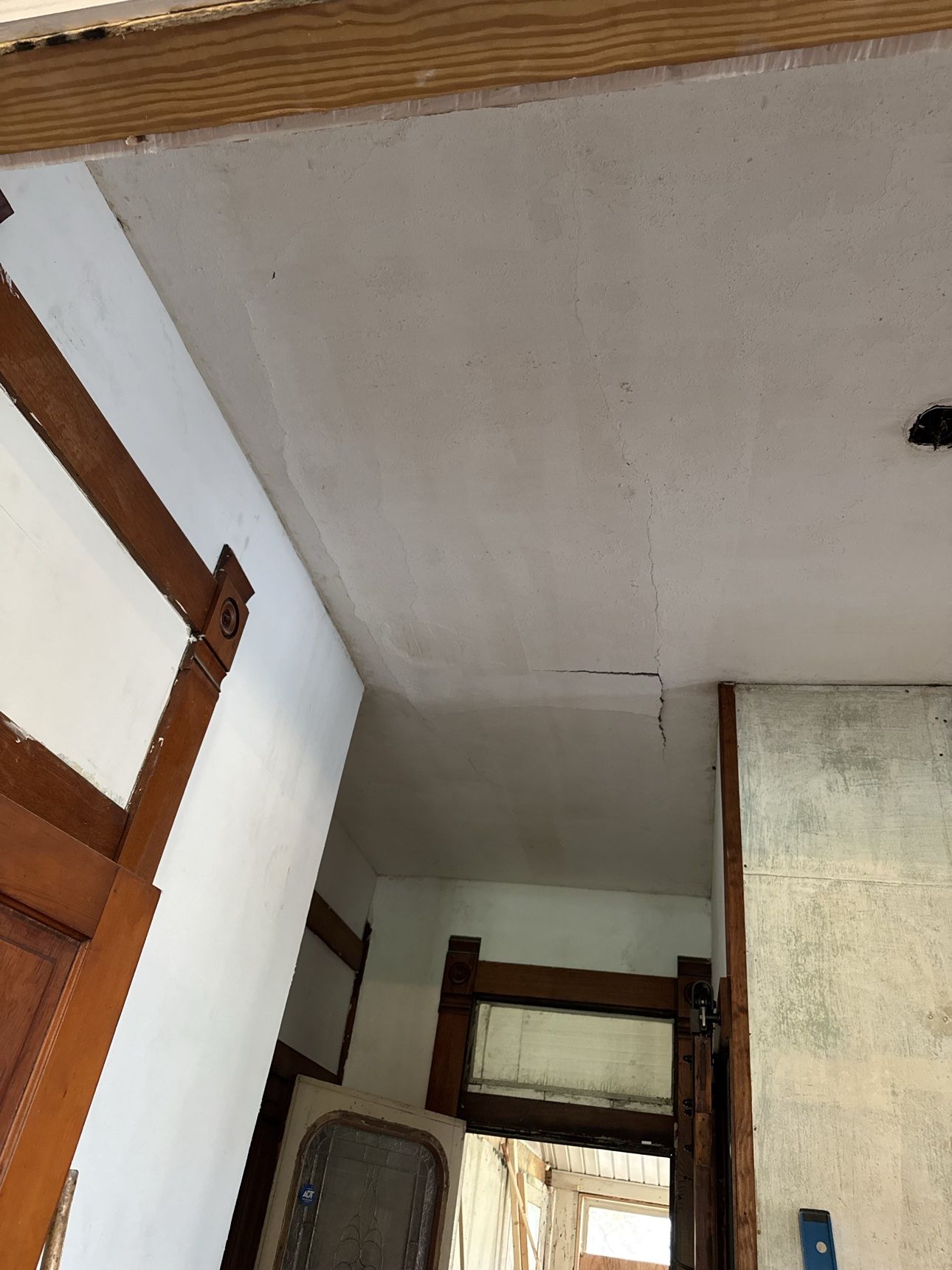 Original lath and plaster hallway ceiling cracked and letting go before restoration
