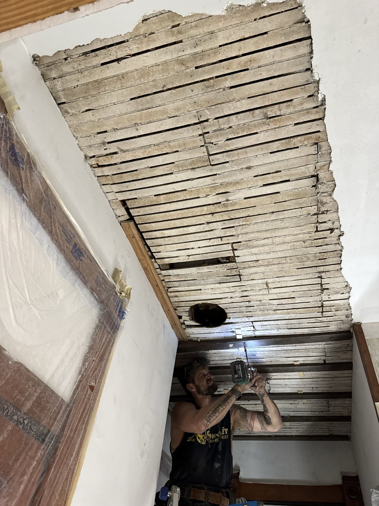 Hallway gutted to the original wood lath during ceiling restoration