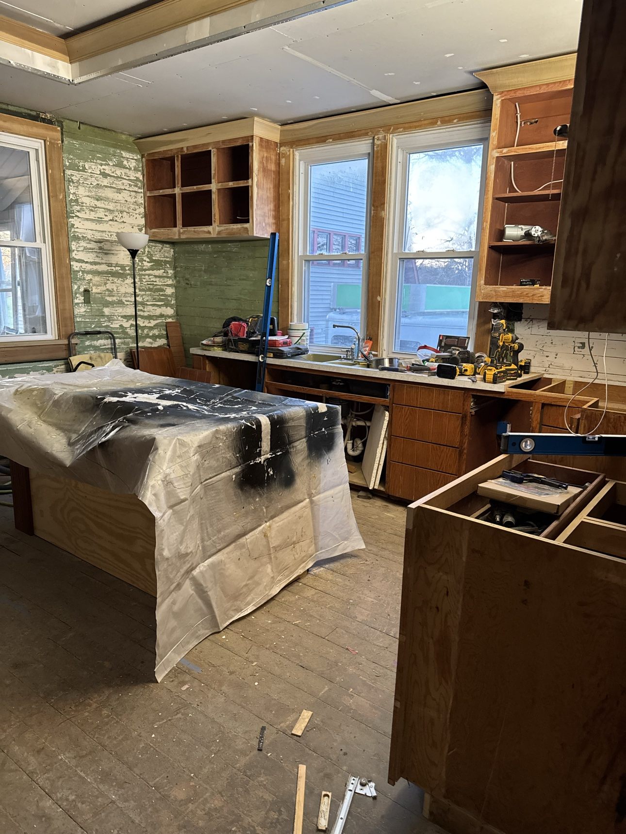 Kitchen remodel in progress in Indianapolis — walls stripped back and new cabinetry being installed